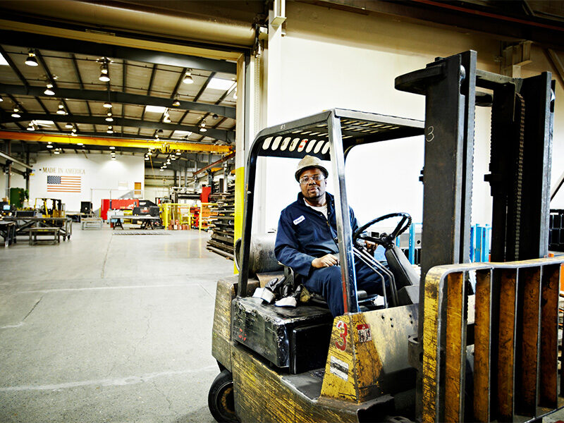Man operating forklift in distribution center.
